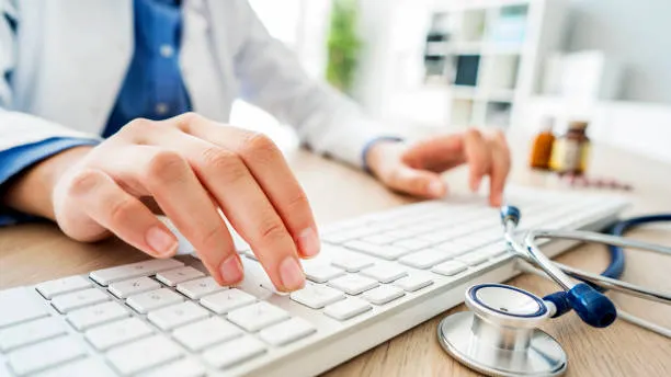 Doctor typing on keyboard